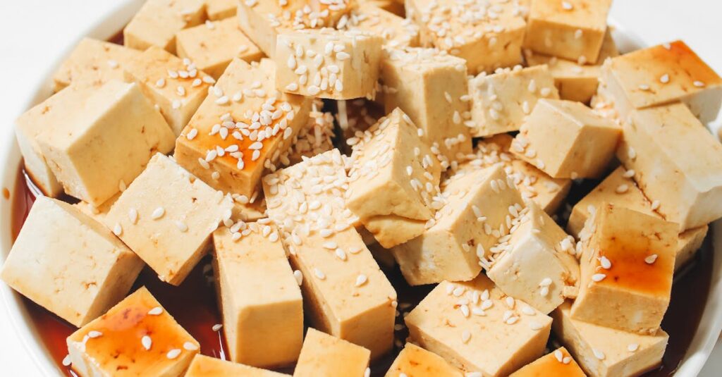 Delicious tofu cubes drizzled with soy sauce and sprinkled with sesame seeds, perfect for a healthy meal.